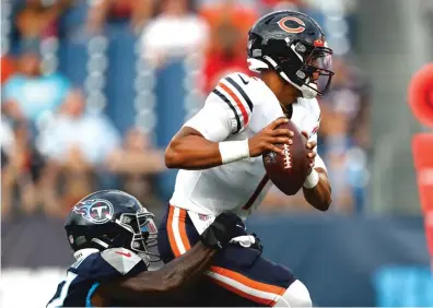  ?? WADE PAYNE/AP ?? Justin Fields was sacked by Titans linebacker Derick Roberson on the Bears’ first drive Saturday.