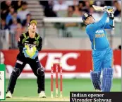  ??  ?? Indian opener Virender Sehwag hits out as Matthew Wade watches