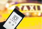  ?? Picture: AFP ?? NOT ’APPY: A cellphone user uses Uber in the city of Jinan in eastern China. Uber is facing a crackdown from authoritie­s in China and cities worldwide