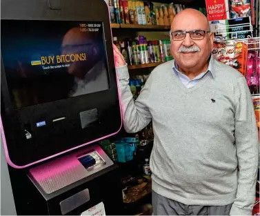  ??  ?? Four customers a day: Harbans Singh Dhiensa with the bitcoin ATM at his shop in Derby
