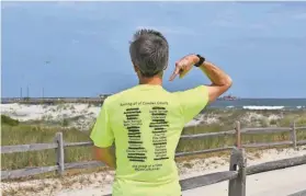  ?? PROVIDED ?? Jack Witzig shows a T-shirt with each of the towns he’s completed crossed off. The Merchantvi­lle resident is running every street in every Camden County municipali­ty to raise money and awareness of Lewy body dementia, which claimed his father’s life in 2016.