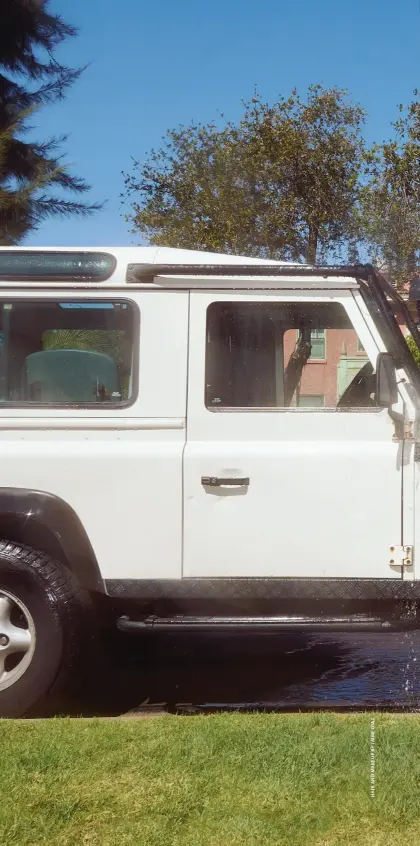  ??  ?? Syd at home in Central Los Angeles, washing one of her cars: Piper, a 1997 Land Rover Defender