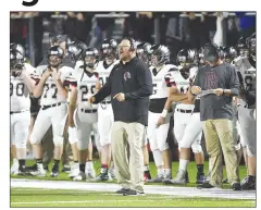  ?? NWA Democrat-Gazette File Photo/Charlie Kaijo ?? Pea Ridge coach Stephen Neal (center) and the Blackhawks will make the move this fall from the 4A-1 to the 5A-West Conference for football. Pea Ridge anticipate­d the move by playing six nonconfere­nce games the last two years against Class 5A schools.