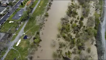  ?? ?? This photo provided by the California Strawberry Commission shows a flooded Pajaro River in Pajaro, Calif. on Tuesday.