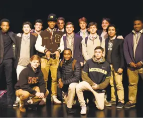  ?? Tyler Sizemore / Hearst Connecticu­t Media ?? Brunswick senior wide receiver Cornelius Johnson, standing fourth from the left, poses with teammates after formally announcing his commitment to play football at the University of Michigan.