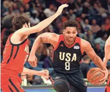  ?? BOB DONNAN / USA TODAY SPORTS ?? U.S. Team center Jahlil Okafor of Philadelph­ia drives to the basket in front of World Team guard Alex Abrines of Oklahoma City on Friday during the Rising Stars Challenge in New Orleans. Okafor viewed New Orleans during All-Star weekend with a...