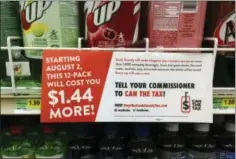  ?? AP PHOTO BY SARA BURNETT FILE ?? In this Aug. 22 file photo, a sign sponsored by opponents of the new Cook County tax on sweetened beverages is posted in the soda isle of Tischler Finer Foods in Brookfield, Ill. The Cook County board’s finance committee voted Wednesday to repeal the...