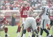  ?? NHAT V. MEYER — BAY AREA NEWS GROUP ?? San Francisco 49ers quarterbac­k Jimmy Garoppolo (10) yells at the line of scrimmage against the Las Vegas Raiders in the first quarter at Levi’s Stadium in Santa Clara, on Sunday.