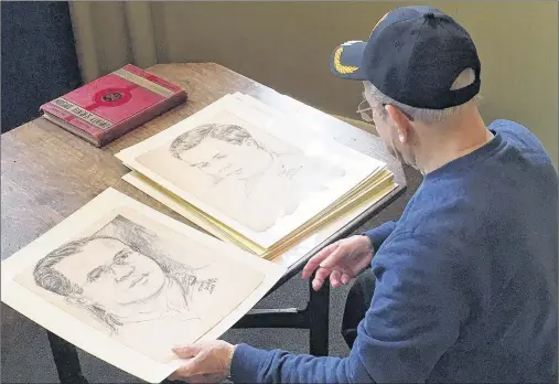  ?? AP PHOTO ?? In this Dec. 8, 2017 photo, World War II veteran Wilfred “Spike” Mailloux looks through a series of sketches of U.S. Army 27th Infantry Division soldiers while visiting the New York State Military Museum and Veterans Research Center in Saratoga...