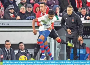  ?? – AFP ?? BILBAO: Barcelona’s Spanish forward #27 Lamine Yamal (FRONT) and Athletic Bilbao’s Spanish forward #07 Alejandro Berenguer vie for the ball during the Spanish league football match between Athletic Club Bilbao and FC Barcelona at the San Mames stadium in Bilbao.