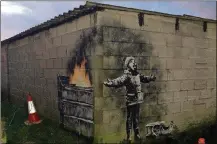  ?? CONTRIBUTE­D ?? British street artist Banksy confirmed that art on a garage wall in Wales was done by him.