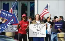  ?? JOHN BAZEMORE/ ASSOCIATED PRESS ?? Supporters of President Donald Trump hold signs during a demonstrat­ion Nov. 5 outside the State FarmArena in Atlanta where Fulton County has a vote counting operation.