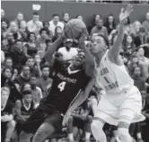  ?? AAron Ontiveroz, The Denver Post ?? Eaglecrest’s Xaiv’ion Jackson attempts to drive by Overland’s Jervae Robinson during the second half of the Raptors’ 57- 45 road victory on Friday.