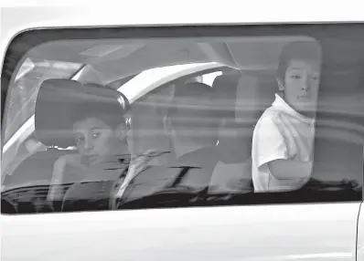  ?? AP Photo/Matt York ?? ■ Children look out a van window as they arrive at Lutheran Social Services on Thursday in Phoenix. The Trump administra­tion on Thursday reunited at least two dozen more migrant families whose separation on the Mexico border drew worldwide condemnati­on and forced the government to ease its “zero-tolerance” immigratio­n policy.