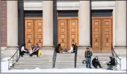  ?? (AP/The Berkshire Eagle/Gillian Jones) ?? in the upper 20s on Sunday, some Williams College students sat on the steps of Chapin Hall in Williamsto­wn, Mass., to bask in the sun.