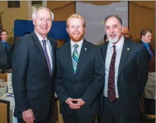  ?? WILLIAM HARVEY/TRILAKES EDITION ?? Gov. Asa Hutchison, from left, visits with Corey Alderdice, director of the Arkansas School for Mathematic­s, Sciences and the Arts, and Bob Gregory, dean of academic affairs, during the Community of Learning Luncheon at the Arlington Hotel in Hot...