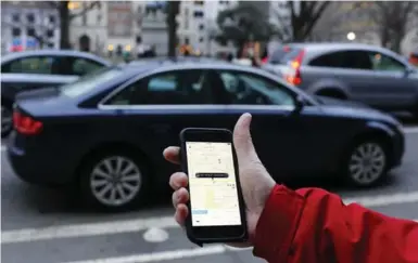  ?? ANDREW CABALLERO-REYNOLDS/AFP/GETTY IMAGES ?? An Ontario Chamber of Commerce report finds that two-thirds of Ontarians think services like Uber are good for the economy.