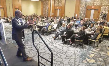  ?? STAFF PHOTOS BY MATT HAMILTON ?? Guest speaker Kevin McNeil, left, speaks during Thursday’s Rise 2023 fundraiser event for Partnershi­p for Families, Children and Adults at the Westin Chattanoog­a.