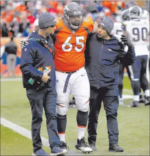  ?? AP PHOTO ?? In this Sunday, Oct. 14 photo, Denver Broncos offensive guard Ronald Leary (65) is helped off the field after an injury against the Los Angeles Rams during the second half of an NFL football game, in Denver. The Broncos have lost guard Leary, their best offensive lineman, to a torn Achilles, the latest misfortune for a team that’s mired in a four-game skid.