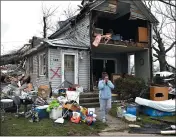  ?? TIMOTHY D. EASLEY — THE ASSOCIATED PRESS ?? Brittany Oakley calls relatives outside of what is left of her home in Lakeview, Ohio, on Friday.