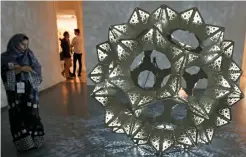  ?? Photos by M. Sajjad ?? Emirati artist Khalid Shafar’s installati­on My Wedding, and; right, In Bloom, an artwork by Toy Studio UK on display during the 20th edition of The Sharjah Islamic Art Festival, which began on Wednesday. Artists from different parts of the world are...