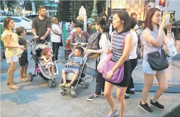  ??  ?? Tourists are seen at Erawan Shrine, a Hindu shrine popular among tourists in central Bangkok,Thailand. Tourism ministry figures reviewed by Reuters showed 52 per cent of more than 32 million visitors last year were women. — Reuters photo