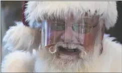  ?? (AP/Ashley Landis) ?? Santa Claus wears a face shield while visiting with children at Bass Pro Shop in Rancho Cucamonga, Calif.