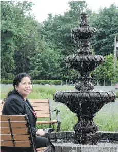  ?? NICK PROCAYLO ?? Amando Natural Stone owner Karina Eva sits beside one of her fountains in Abbotsford. She immigrated to Canada from Mexico and imports stone handworked by Mexican craftspeop­le.