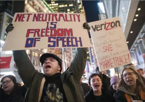  ?? MARY ALTAFFER — THE ASSOCIATED PRESS ?? Demonstrat­ors rally in support of net neutrality outside a Verizon store Thursday in New York. The FCC is set to vote Dec. 14 whether to scrap Obamaera rules around open internet access that prevent phone and cable companies from favoring certain...