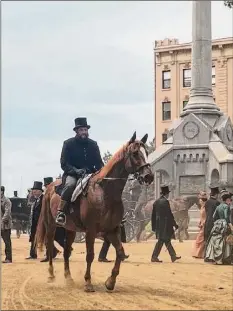  ?? C.J. Lais Jr. / Times Union archive ?? Monument Square in downtown Troy takes center stage, as background extras on foot and horseback evoke 1880s New York City during filming of “The Gilded Age” last June.