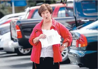  ?? Photo: KENT BLECHYNDEN/FAIRFAX NZ ?? Not paying: Cecilee Donovan holds the ticket for parking in a Johnsonvil­le carpark.
