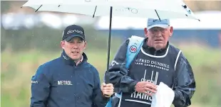  ?? Picture: Getty. ?? Richie Ramsay shelters from the rain at St Andrews.