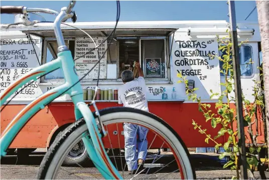  ?? Fotos de Mark Mulligan / Houston Chronicle ?? María Samano atiende su negocio de tacos Tierra Caliente en una de las esquinas de la intersecci­ón de las calles West Alabama y McDuffie en Houston.