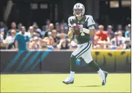  ?? Phelan M. Ebenhack / Associated Press ?? Jets quarterbac­k Sam Darnold rolls out to throw a pass during the first half against the Jacksonvil­le Jaguars on Sept. 30. While Darnold is flattered that Denver linebacker Von Miller has high praise for him, he knows Miller will be looking to clean his clock.