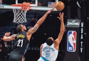  ?? Corey Sipkin / Associated Press ?? Los Angeles Lakers guard Talen Horton-Tucker (5) is blocked by Brooklyn Nets center LaMarcus Aldridge on Saturday in New York.