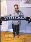  ??  ?? Nine-year-old Daisy Earle with her Scotland scarf, which she received at Murrayfiel­d Stadium.