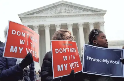  ?? WIN MCNAMEE/GETTY IMAGES ?? As demonstrat­ors rallied, the Supreme Court struggled to find a standard for election maps.