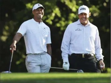  ?? CURTIS COMPTON — THE ASSOCIATED PRESS ?? Tiger Woods, left, and Phil Mickelson will face off Nov. 23 in Las Vegas for a pay-per-view event.