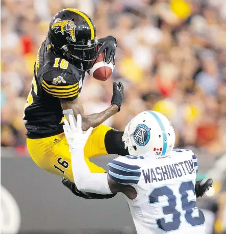  ?? PETER POWER/THE CANADIAN PRESS ?? Hamilton Tiger-Cats wide receiver Brandon Banks goes high to snare a touchdown pass against DB Truman Washington of the Argonauts during Monday’s other Labour Day Classic. Hamilton’s 42-28 win came with 18 unanswered points in the fourth quarter.