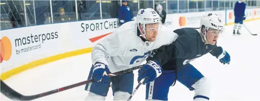  ?? RENÉ JOHNSTON TORONTO STAR ?? Connor Brown, left, and Jake Gardiner battle in the corner during drills at the Maple Leafs practice facility on Monday.