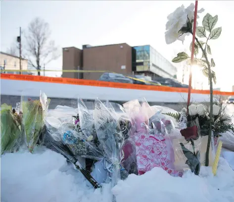  ?? ALICE CHICHE/AFP/GETTY IMAGES ?? Flowers line a makeshift memorial near the Islamic Cultural Centre in Quebec City on Monday after a gunmen stormed into a mosque during evening prayers on Sunday and opened fire on worshipper­s, killing six and wounding eight in what Prime Minister...