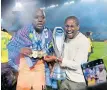  ?? BackpagePi­x ?? GOALKEEPER Denis Onyango, seen here with Sundowns coach Rulani Mokwena, has now won 11 league titles in South African football. |