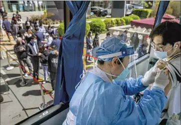  ?? Wang Weiwei VCG ?? A MOBILE CLINIC offers COVID-19 vaccinatio­ns Tuesday in Beijing. The efficacy of the Chinese-made Sinopharm and Sinovac vaccines has been questioned amid a lack of transparen­cy around trial data.