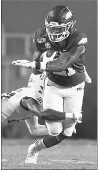  ?? NWA Democrat-Gazette/CHARLIE KAIJO ?? Arkansas running back Devwah Whaley (right) carries the ball Saturday during the second quarter as a San Jose State defender goes for the tackle at Donald W. Reynolds Razorback Stadium in Fayettevil­le.