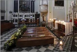  ?? CLAUDIO FURLA — LAPRESSE VIA AP ?? Coffins in a church in Serina, near Bergamo, Northern Italy, wait to be transporte­d to a cemetery Saturday. Italy announced nearly 800new deaths and 6,600new virus cases.