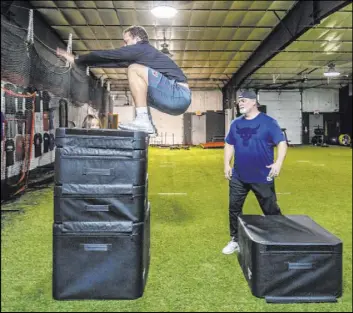  ?? L.E. Baskow Las Vegas Review-Journal @Left_Eye_Images ?? Raiders fullback Alec Ingold vertically leaps onto a stack of pads under the guidance of trainer Brian Bott. “No shortcuts,” Ingold says of his daily workouts.