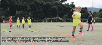  ?? 01_B31hockeyc­amp02 ?? Children practise their agility and foot control techniques under the watchful eye of Marie-Louise Craig.