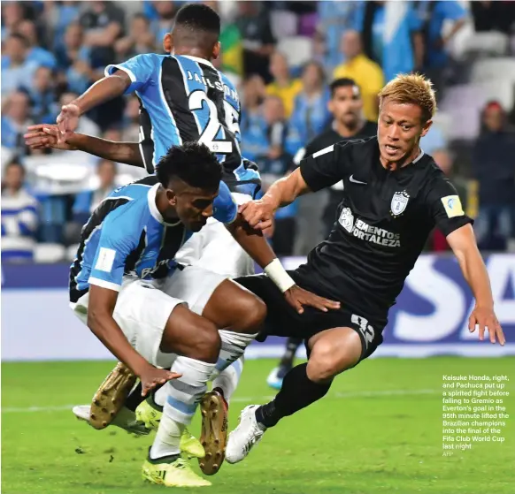  ?? AFP ?? Keisuke Honda, right, and Pachuca put up a spirited fight before falling to Gremio as Everton’s goal in the 95th minute lifted the Brazilian champions into the final of the Fifa Club World Cup last night