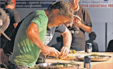  ?? DESIREE ANSTEY/JOURNAL PIONEER ?? Peter Quigley, from Kamloops, B.C., came to crack open oysters for the very first time while on stage in front of thousands of spectators and live television broadcasti­ng.