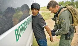  ?? MATT YORK/AP ?? Before being transporte­d, a migrant has his handcuffs removed by a U.S. Border Patrol agent Sept. 8 at the foot of the Baboquivar­i Mountains near Sasabe, Arizona.